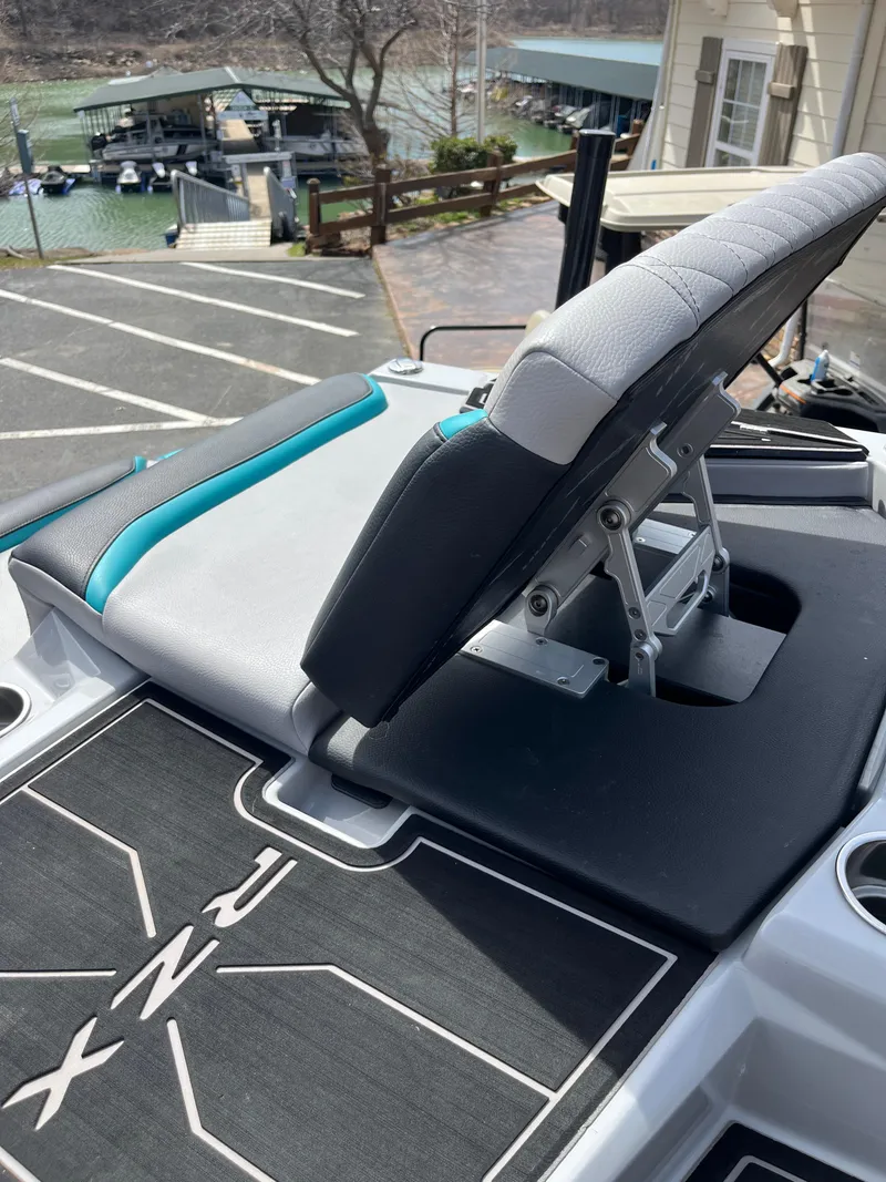 Slide: The Image of 2023 Tigé 22RZX boat seat with adjustable backrest, dockside view. - 23