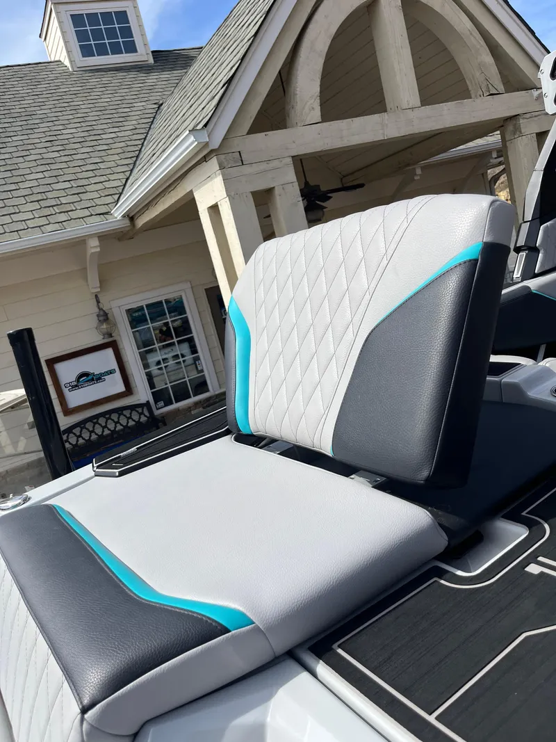 Slide: The Image of 2023 Tigé 22RZX boat seat with modern design and blue accents, near a building. - 26