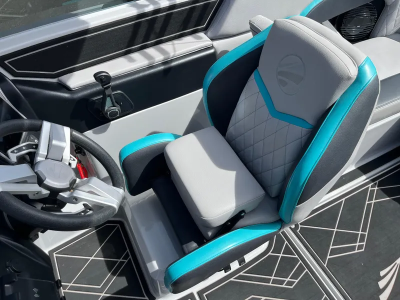 Slide: The Image of 2023 Tigé 22RZX boat interior with modern steering wheel and stylish seating. - 32