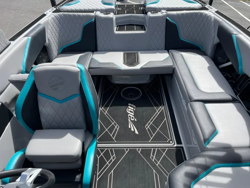 Slide: The Image of 2023 Tigé 22RZX boat interior with gray and teal seating, modern design. - 34