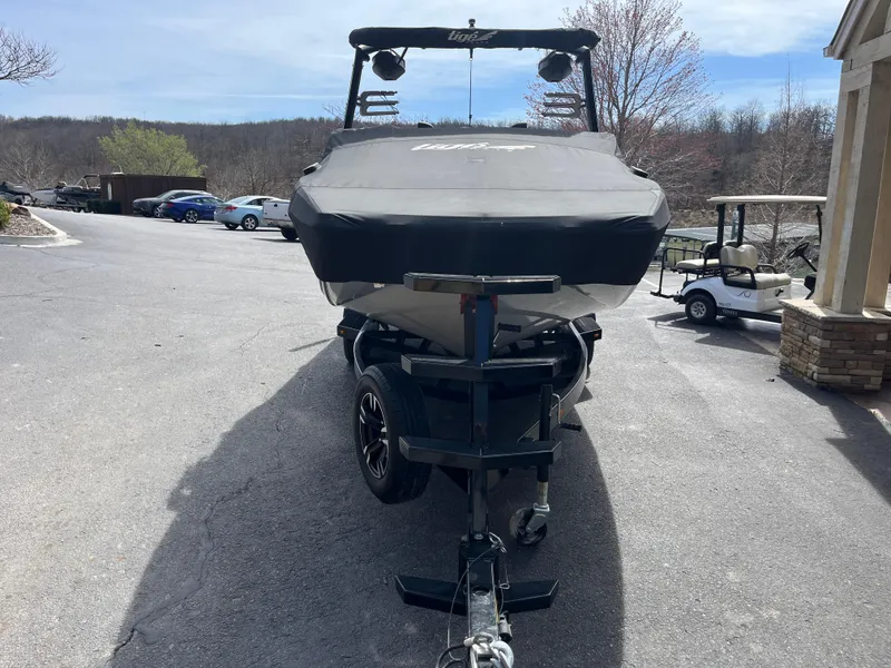 Slide: The Image of 2023 Tigé 22RZX boat on trailer, covered, parked outdoors. - 8
