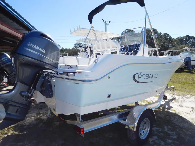 The Image of 2025 Robalo R180 Center Console boat with Yamaha engine on trailer. - 1