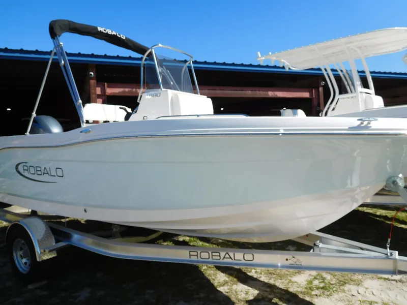 Slide: The Image of 2025 Robalo R180 Center Console boat on trailer, side view. - 2