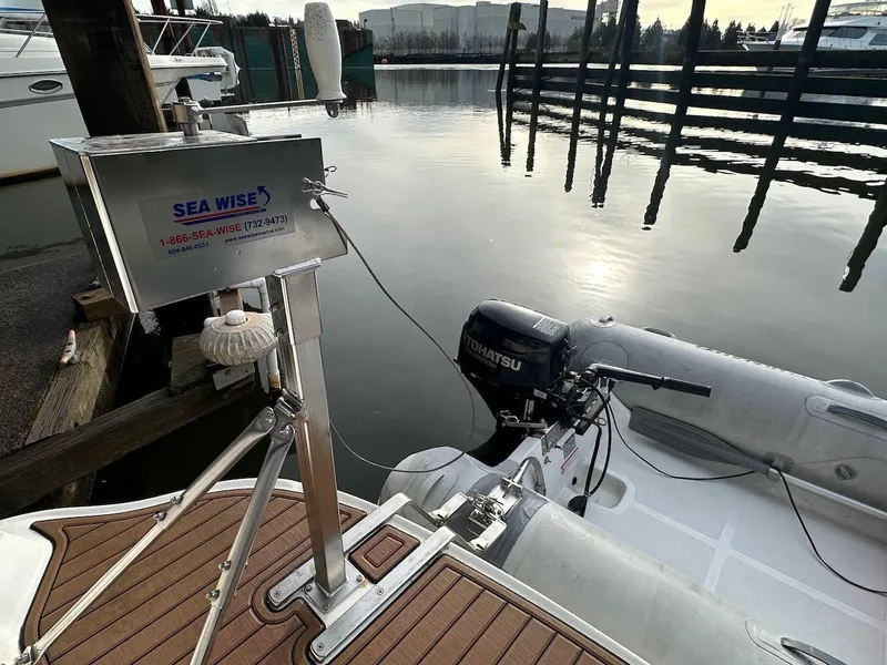 Slide: The Image of 2004 Sea Ray 340 Sundancer with Tohatsu motor and Sea Wise lift at dock. - 17