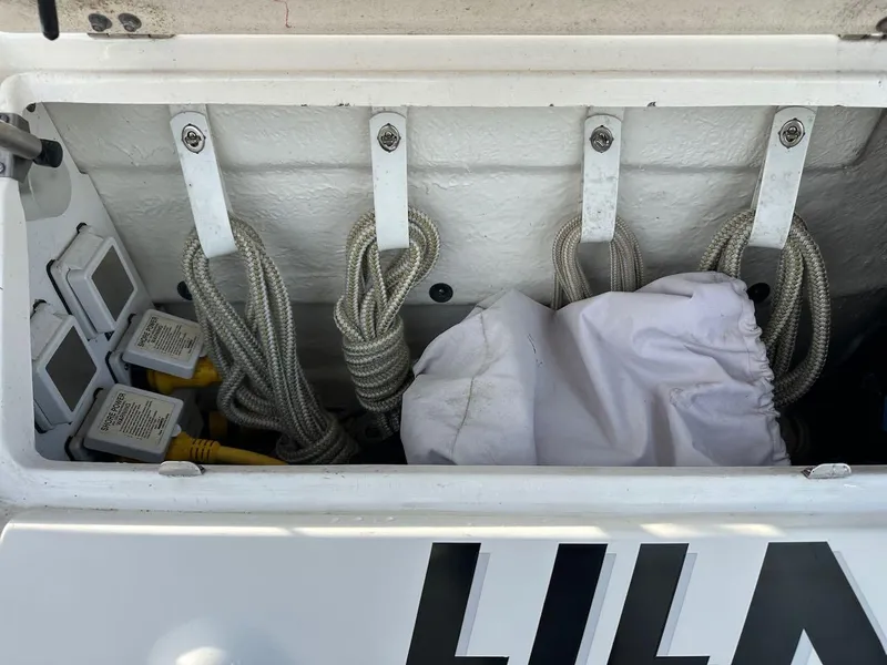 Slide: The Image of Storage compartment on a 2004 Sea Ray 340 Sundancer boat with ropes and equipment. - 19