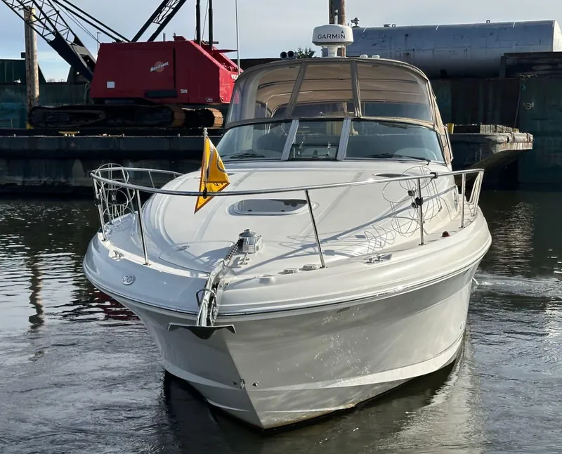 Slide: The Image of 2004 Sea Ray 340 Sundancer boat docked in a marina, front view. - 2