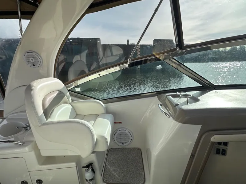 Slide: The Image of 2004 Sea Ray 340 Sundancer cockpit with white seating and water view. - 28