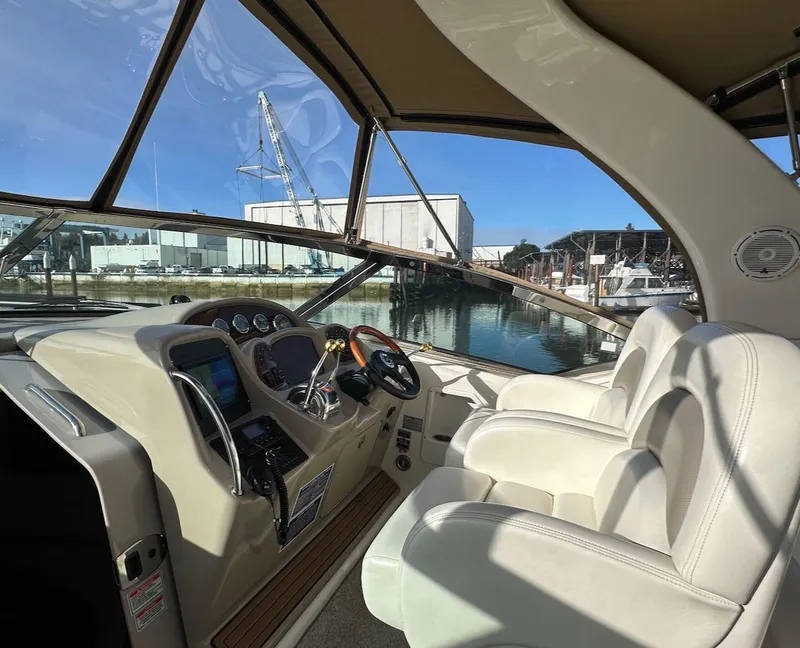 Slide: The Image of 2004 Sea Ray 340 Sundancer cockpit with leather seats and marina view. - 29