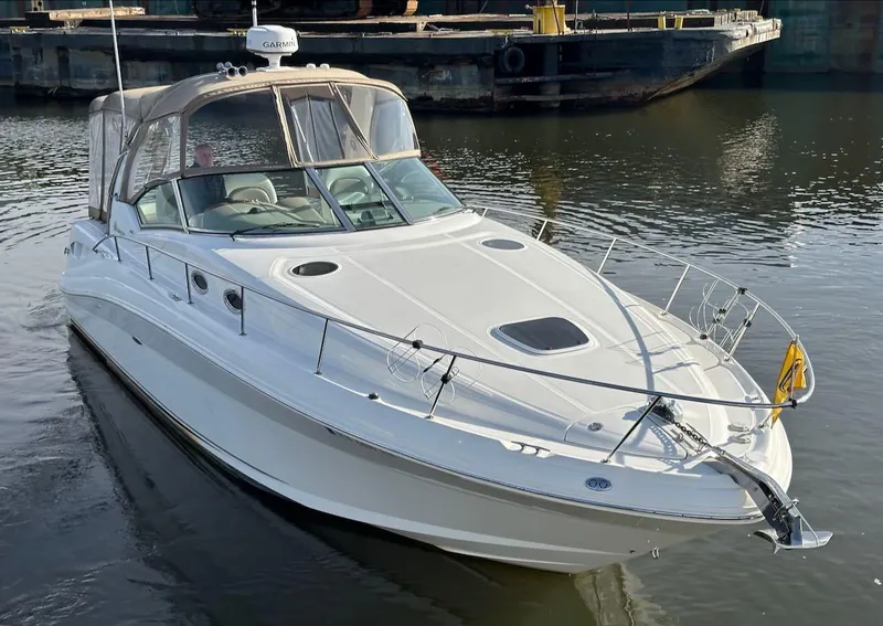 Slide: The Image of 2004 Sea Ray 340 Sundancer boat on calm water, featuring sleek design and spacious deck. - 3