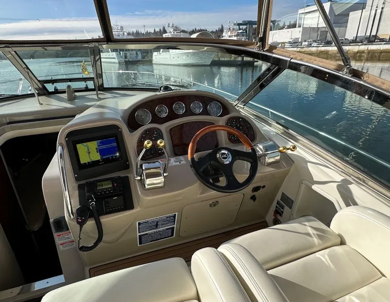 Slide: The Image of 2004 Sea Ray 340 Sundancer helm with navigation controls and leather seating. - 30