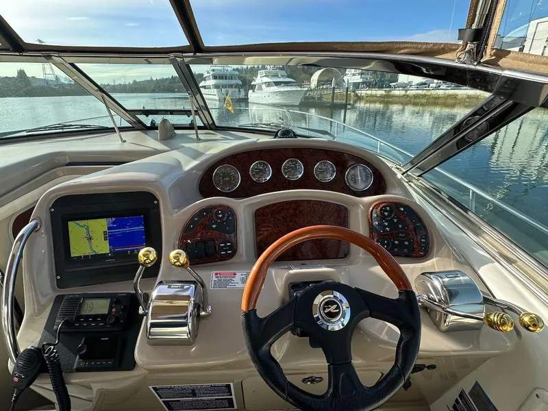 Slide: The Image of Cockpit view of 2004 Sea Ray 340 Sundancer with navigation system and controls. - 32