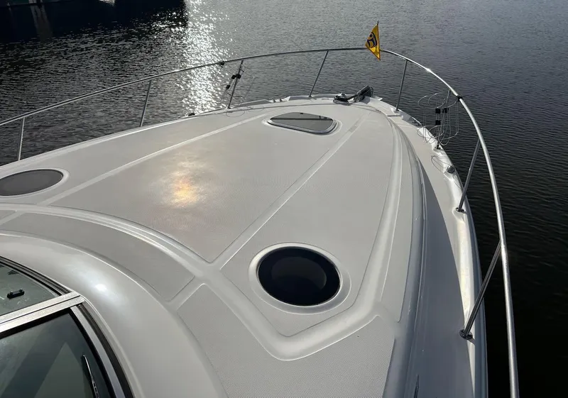 Slide: The Image of 2004 Sea Ray 340 Sundancer boat deck with water reflection and railing. - 4