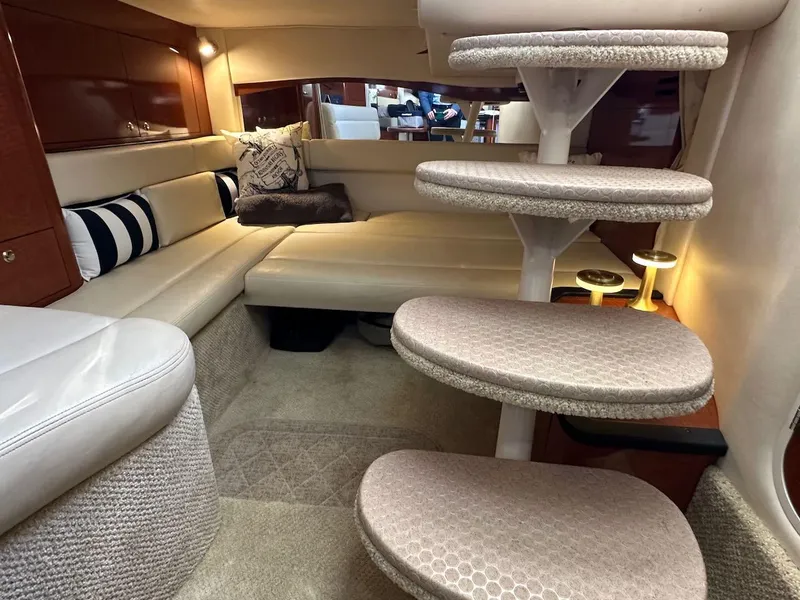 Slide: The Image of Interior of 2004 Sea Ray 340 Sundancer yacht with plush seating and elegant staircase. - 44