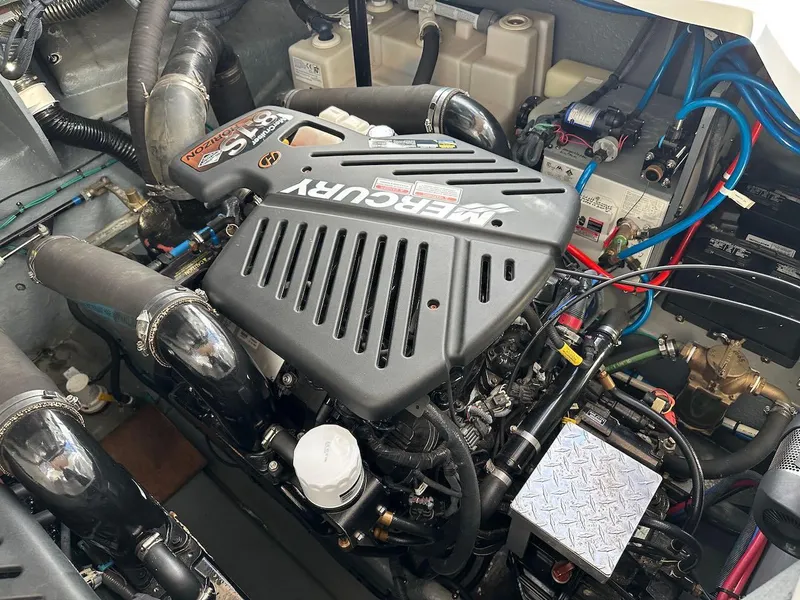 Slide: The Image of Engine compartment of a 2004 Sea Ray 340 Sundancer with Mercury engine components. - 49