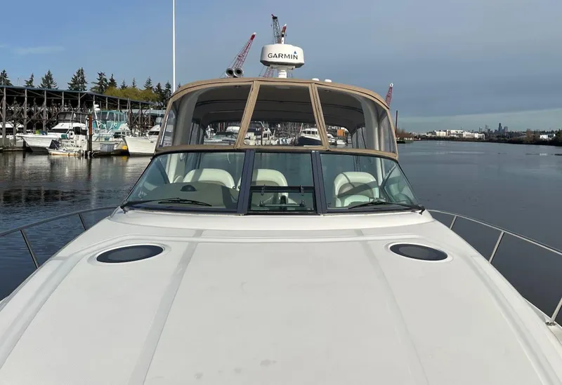 Slide: The Image of 2004 Sea Ray 340 Sundancer yacht docked in a marina, front view. - 8