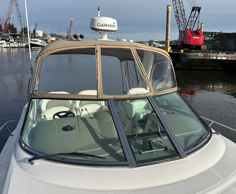 Slide: The Image of 2004 Sea Ray 340 Sundancer boat docked, featuring Garmin radar and beige canopy. - 9