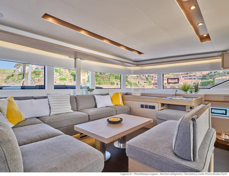 Slide: The Image of Luxurious interior of 2025 Lagoon 51 ICONIC yacht with modern seating and panoramic windows. - 34