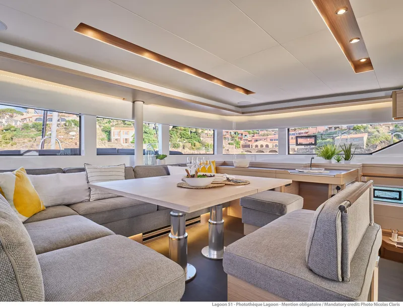 Slide: The Image of Luxurious interior of 2025 Lagoon 51 ICONIC yacht with modern seating and dining area. - 35