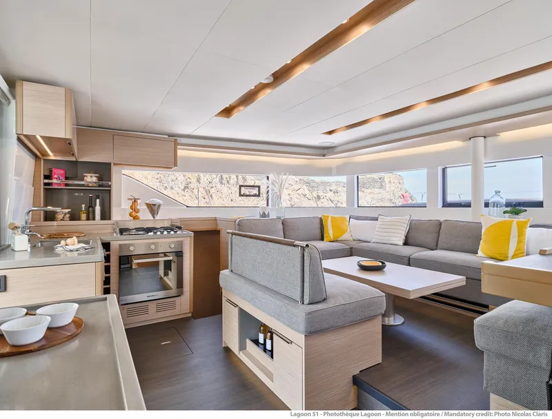 Slide: The Image of Luxurious interior of 2025 Lagoon 51 ICONIC yacht with modern kitchen and spacious seating area. - 37