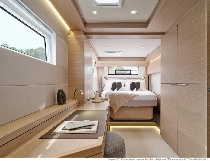 Slide: The Image of Luxurious interior of 2025 Lagoon 51 ICONIC yacht, featuring a modern bedroom with elegant wood finishes. - 46