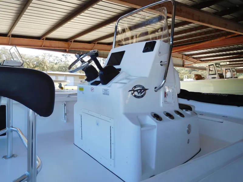 Slide: The Image of 2025 Tidewater 2110 Bay Max boat console under a metal roof. - 3