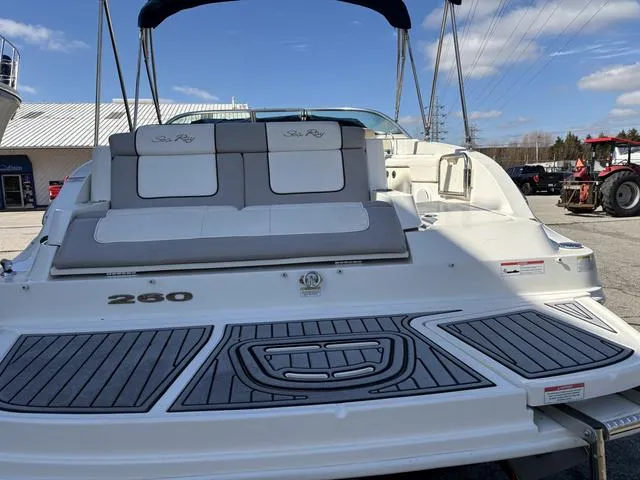 Slide: The Image of 2011 Sea Ray 260 Sundeck interior with open storage compartment and sink. - 10