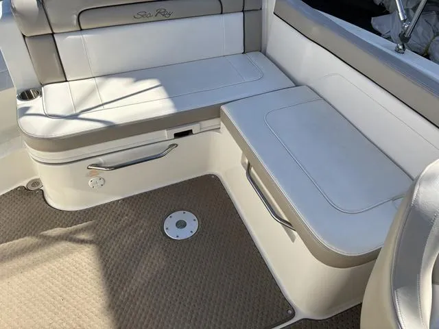 Slide: The Image of 2011 Sea Ray 260 Sundeck storage compartment with open lid, showcasing interior space. - 13