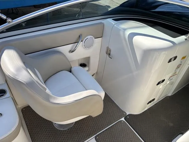 Slide: The Image of 2011 Sea Ray 260 Sundeck interior with white captain's chair and sleek dashboard design. - 14