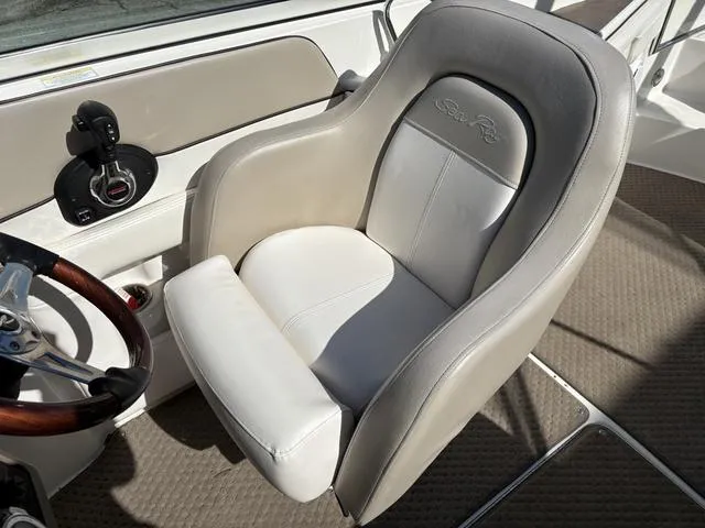 Slide: The Image of Captain's chair in 2011 Sea Ray 260 Sundeck boat cockpit, featuring sleek design and comfort. - 17