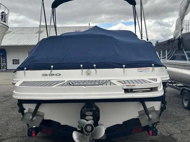 Slide: The Image of 2011 Sea Ray 260 Sundeck interior seating with beige upholstery and carpeted flooring. - 5