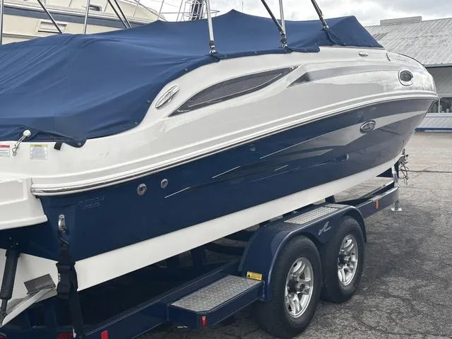 Slide: The Image of 2011 Sea Ray 260 Sundeck interior with white captain's chair and dashboard. - 6