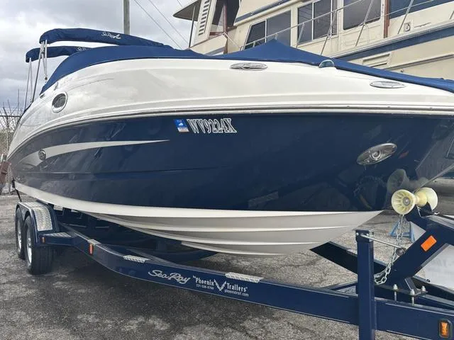 Slide: The Image of 2011 Sea Ray 260 Sundeck interior with compact marine toilet and storage space. - 7