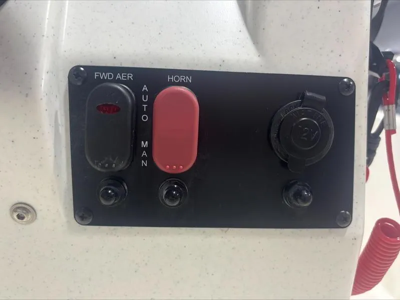 Slide: The Image of Control panel of 2025 Mako Skiff 15 CC boat with switches and outlets. - 11
