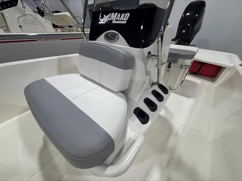 Slide: The Image of 2025 Mako Skiff 15 CC boat interior with cushioned seating and console. - 12