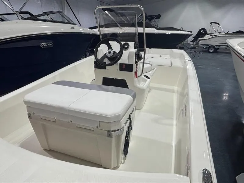 Slide: The Image of 2025 Mako Skiff 15 CC boat interior with steering console and seating. - 4