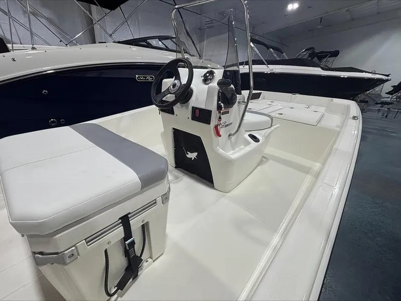 Slide: The Image of 2025 Mako Skiff 15 CC boat interior with steering console and seating. - 5