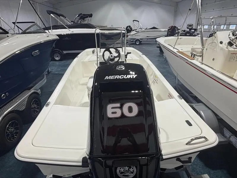 Slide: The Image of 2025 Mako Skiff 15 CC with Mercury 60 engine in showroom. - 8