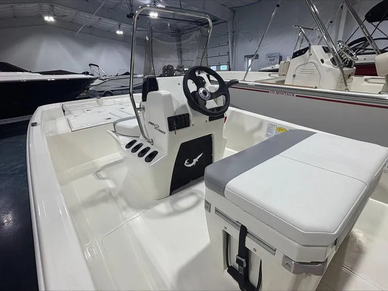 Slide: The Image of 2025 Mako Skiff 15 CC boat interior with steering console and seating. - 9