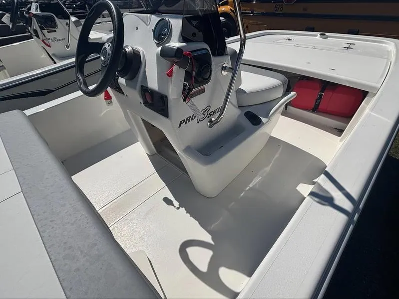 Slide: The Image of 2025 Mako SKIFF 13 CC boat interior with steering console and seating. - 10