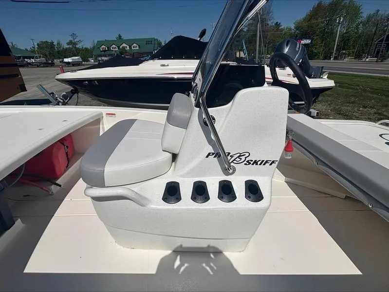 Slide: The Image of 2025 Mako SKIFF 13 CC boat interior with seating and steering console. - 11