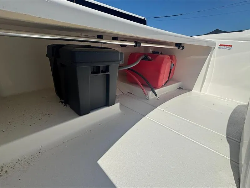 Slide: The Image of 2025 Mako SKIFF 13 CC boat storage area with battery and fuel tank. - 12