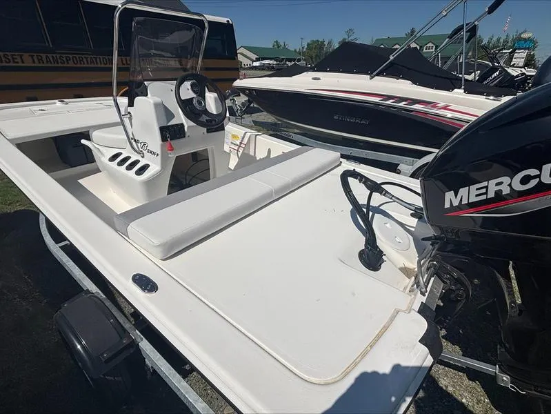 Slide: The Image of 2025 Mako SKIFF 13 CC boat with Mercury engine, parked outdoors. - 5