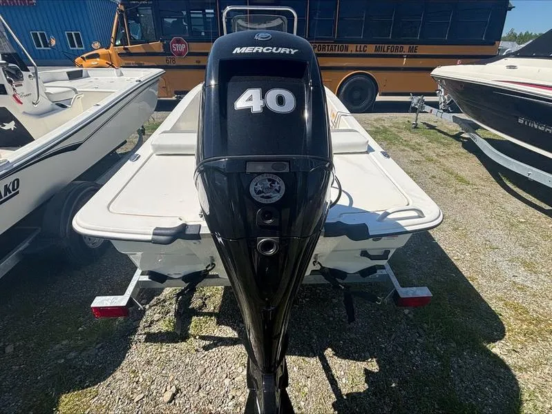 Slide: The Image of 2025 Mako SKIFF 13 CC boat with Mercury 40 outboard motor, parked outdoors. - 8