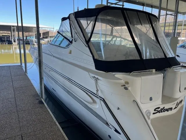 The Image of 1998 Maxum 4100 SCR yacht docked in marina, featuring sleek design and covered cockpit. - 0