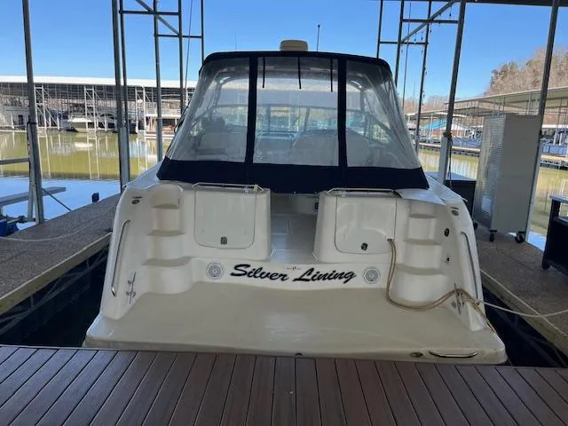 Slide: The Image of 1998 Maxum 4100 SCR yacht named "Silver Lining" docked in a marina. - 11