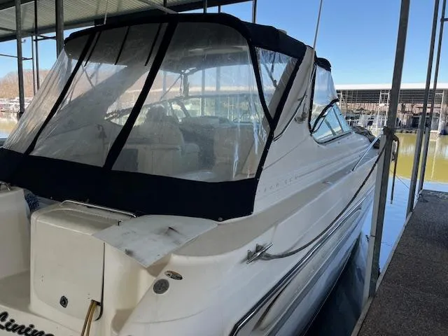 Slide: The Image of 1998 Maxum 4100 SCR boat docked under a covered marina. - 2