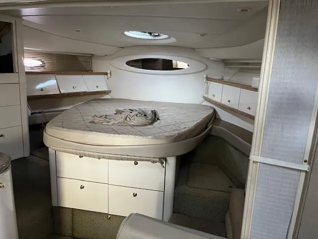 Slide: The Image of Interior cabin of 1998 Maxum 4100 SCR yacht with circular bed and storage. - 4