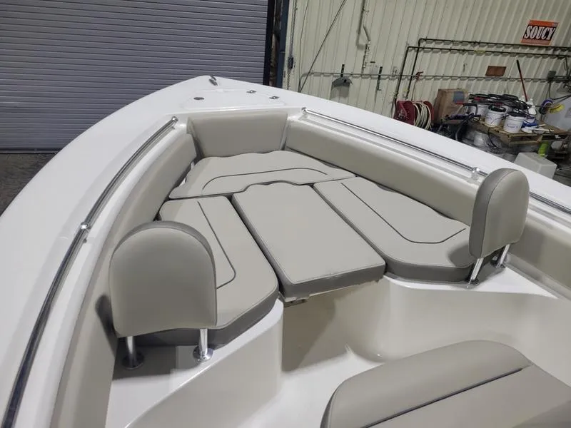 Slide: The Image of 2022 Key West 219fs boat interior with cushioned seating and storage compartments. - 13