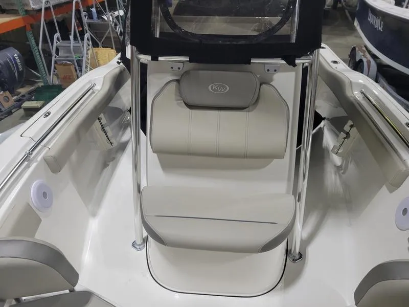 Slide: The Image of 2022 Key West 219fs boat interior with cushioned seating and sleek design. - 14