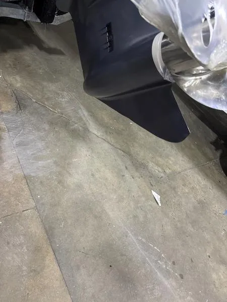 Slide: The Image of 2022 Key West 219fs boat detail, showcasing a sleek black fin on a concrete floor. - 16